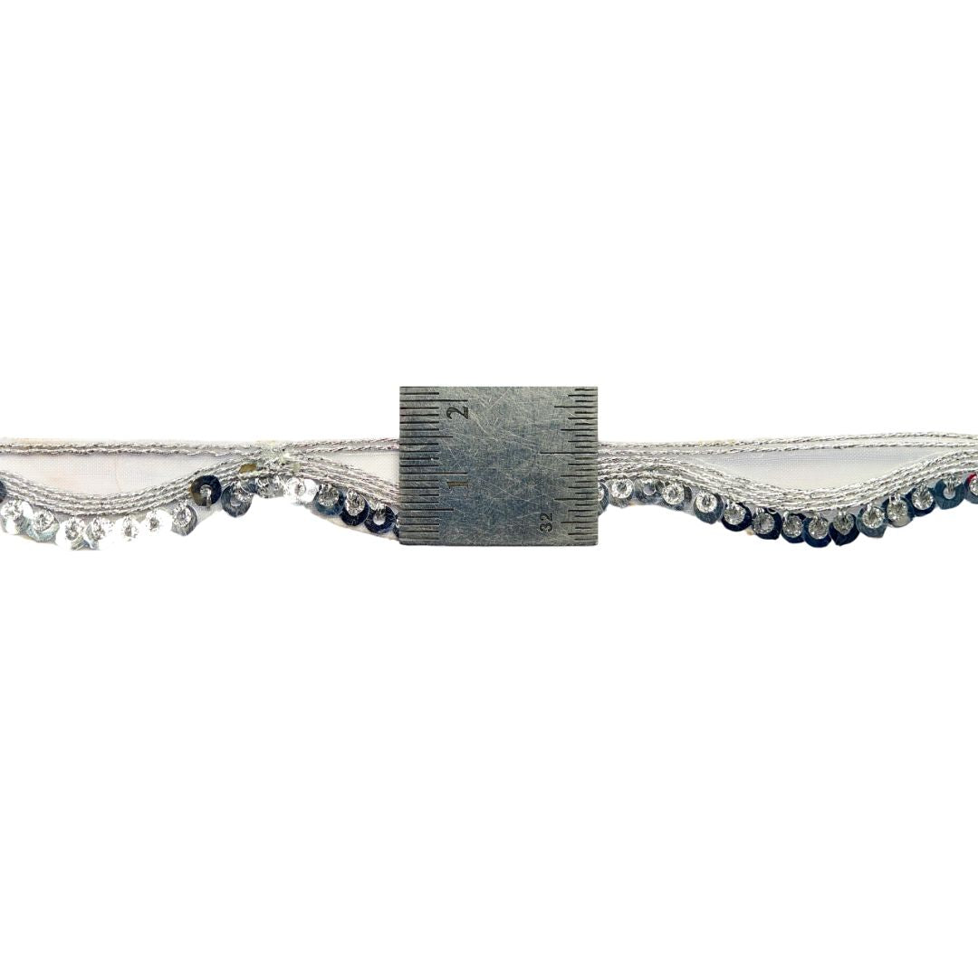 Decorative trim with lace and beads on a white background